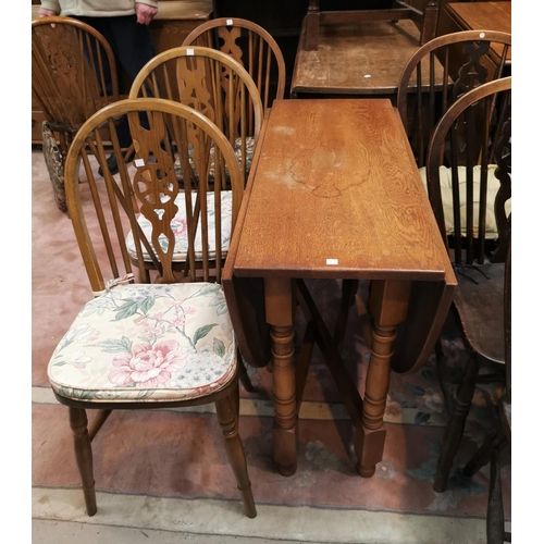 631 - An oak oval drop leaf dining table; 4 wheel back  dining chairs