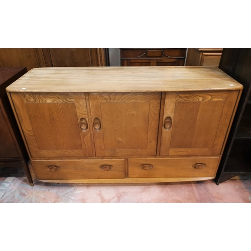 653 - An Ercol lightwood sideboard of double and single cupboard and double drawers under, length 128cm
