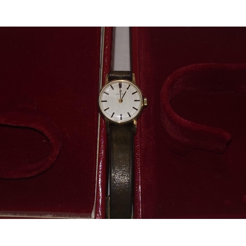 362 - A ladies Omega wristwatch in yellow metal case with brown leather strap