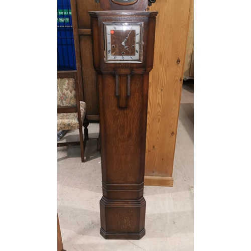 542 - A 1930's oak corner fitting granddaughter clock with Westminster chimes