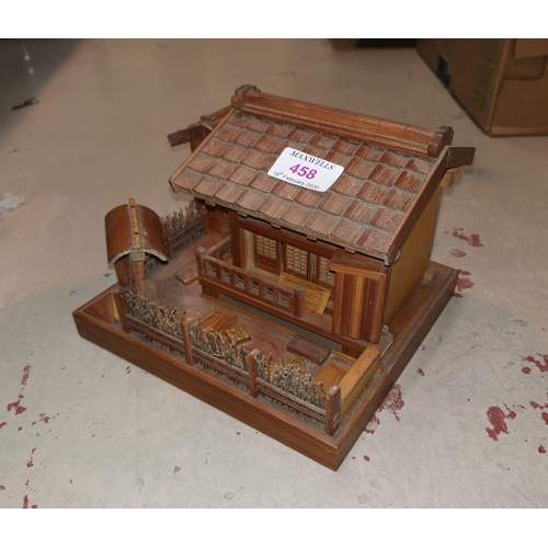 458 - A mid 20th century Japanese wooden model house; dolls and collectors items