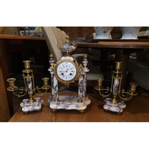 500a - A Louis XVI style clock garniture, the central clock with white dial decorated with floral swags, wi... 