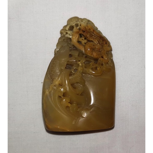 133A - A Chinese carved and pierced hardstone with dragon and leaping carp, beige and brown, 7.5cm