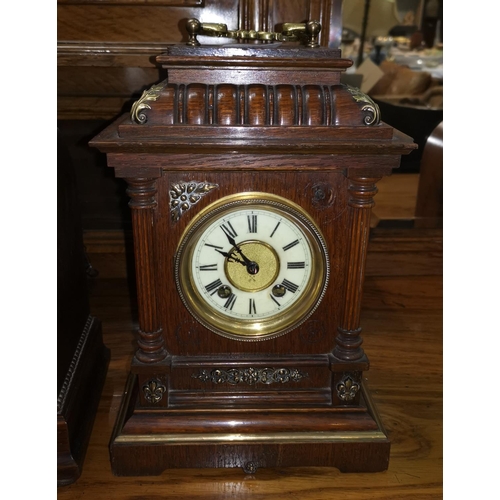492 - An oak cased mantel clock with brass mounts