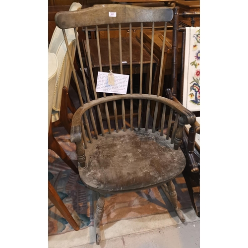 557 - A late 19th/early 20th century stick back rocking chair