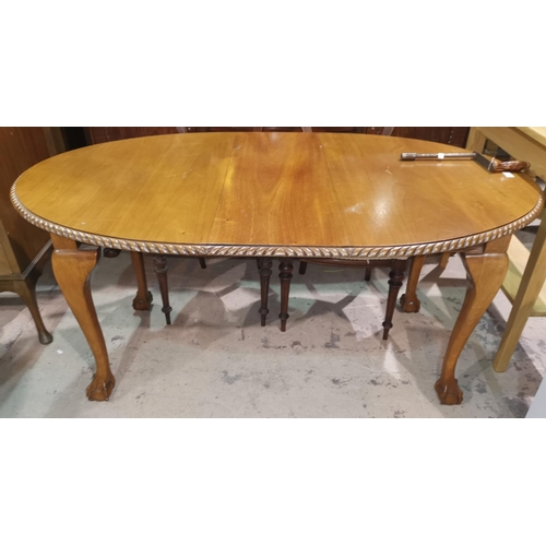 564 - A period style mahogany wind out dining table, the oval top with gadrooned border, on ball and claw ... 