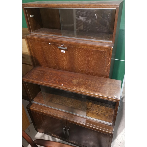 608 - A 1950's Minty oak sectional side cabinet secretaire; a similar 2 height bookcase