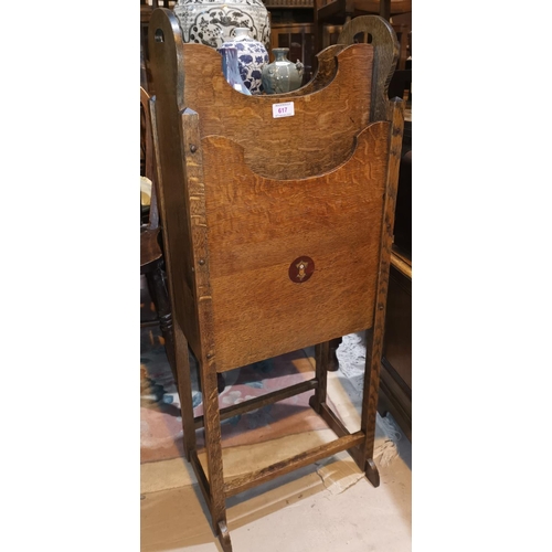 617 - An early 20th century Arts & Crafts oak magazine rack, inset inlaid roundel to each side, width 38 c... 