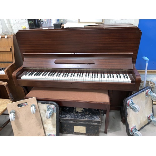 660A - A small modern mahogany cased iron framed overstrung piano by STEINMETZ
