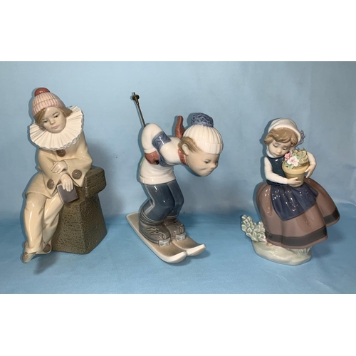 84 - 3 Lladro figures of children - boy clown, boy skiing, girl with flowers