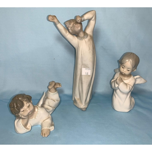 138 - Two Lladro cherubs and a bisque figure of a boy yawning