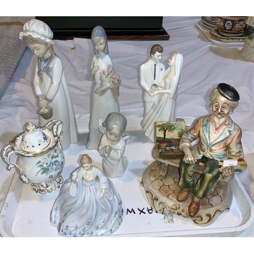 140 - A Royal Doulton group 'Wedding Vows' HN 2750; a Coalport lady 'June'; a small Coalport double handle... 