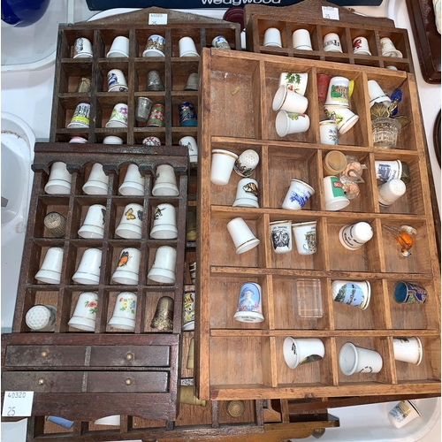 25 - A large collection of china thimbles with wall display shelf unit