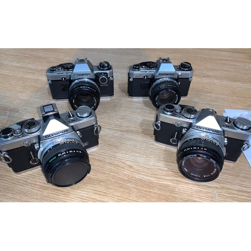 751A - A group of 4 Olympus SLR cameras 2 x OMI & 2  x OM10, a selection of lenses, teleconvertors, a Cento... 