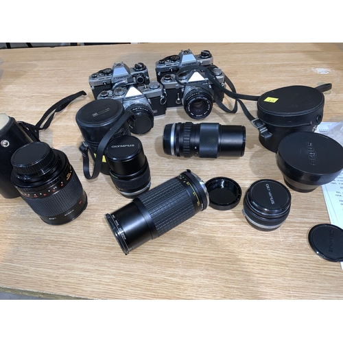 751A - A group of 4 Olympus SLR cameras 2 x OMI & 2  x OM10, a selection of lenses, teleconvertors, a Cento... 