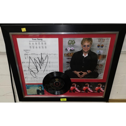 232 - An Elton John framed display containing sheet music for 