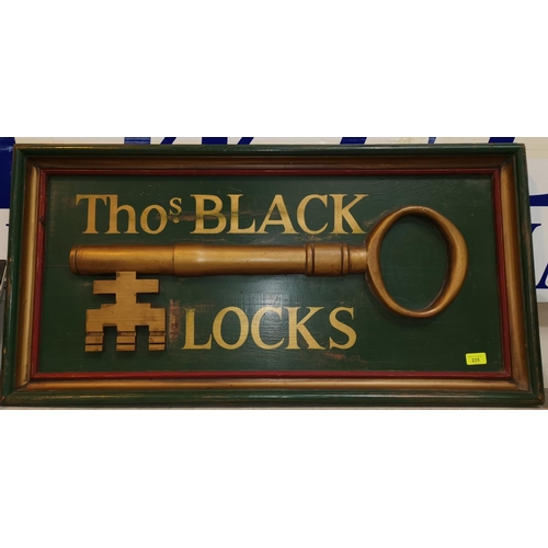 235 - A vintage wooden sign Tho.s Black Locks decorated with key in relief