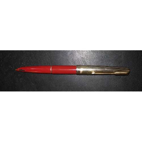 288 - A Parker 61 red first edition fountain pen with gilt lid (a.f.)