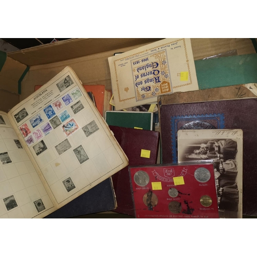 331 - A selection of stamps in albums, various postcards, a coin set etc