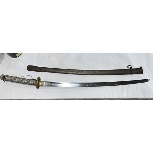 750 - A World War two Japanese katana with metal scabbard and metal alloy handle blade numbered 28147