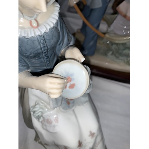 137 - A Lladro figure of a seated girl with embroidery, 28cm (thumb a.f.)