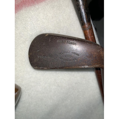 794 - An early 20th century golf bag containing a hard forged mashie St Andrews & 3 other clubs