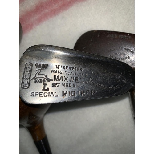 794 - An early 20th century golf bag containing a hard forged mashie St Andrews & 3 other clubs