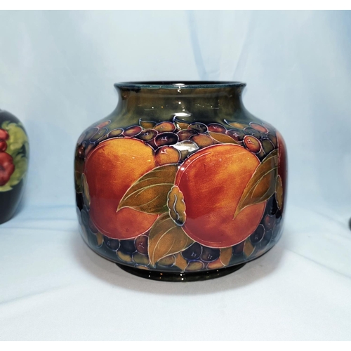 158 - A Moorcroft pottery pomegranite vase of squat form (chip to rim) 15cm