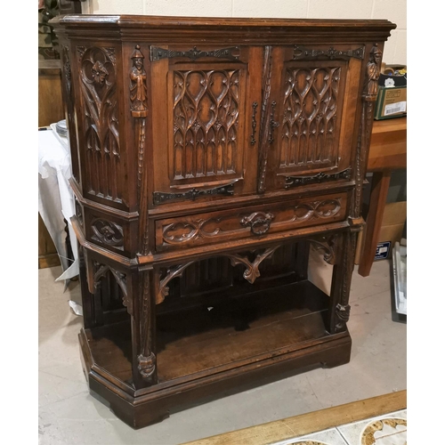 643 - A 19th century oak Gothic style side cabinet with canted front, twin tracery work doors, drawer and ... 