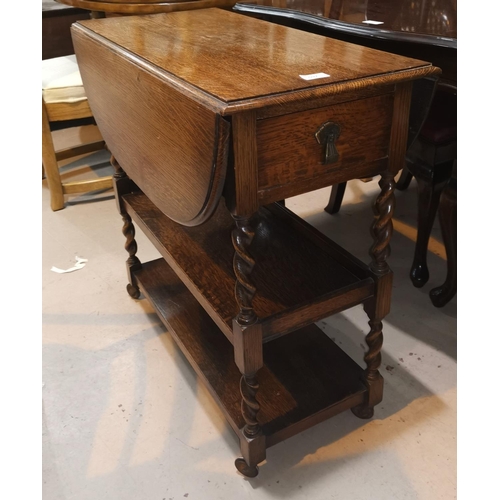 597 - A 1930's oak 3 height drop leaf tea trolley on barley twist supports