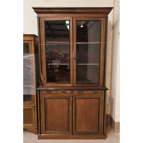 562 - An Edwardian full height bookcase with ebonised mouldings, twin glazed doors over 2 drawers and 2 cu... 