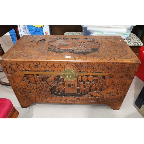 567 - A large oriental carved camphor wood chest with extensive carving