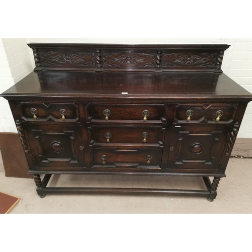 579 - A 1930's oak sideboard of 5 drawers and 2 cupboards, geometric moulded decoration