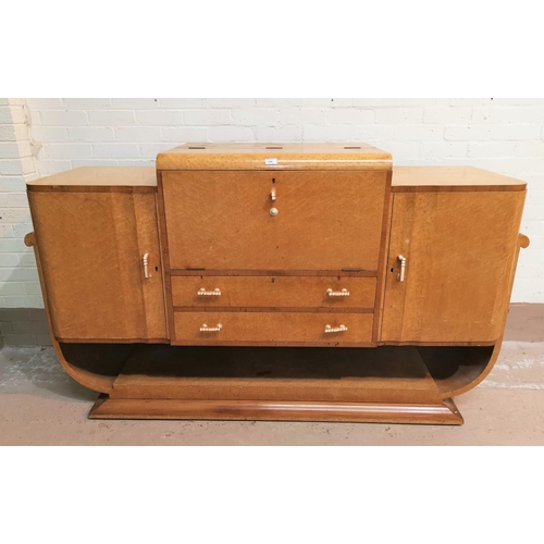 599 - A bird's eye maple Art Deco dining suite with walnut crossbanding, comprising shaped rectangular tab... 