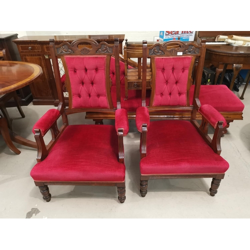 619 - An Edwardian mahogany armchairs and a footstool, upholstered in wine dralon