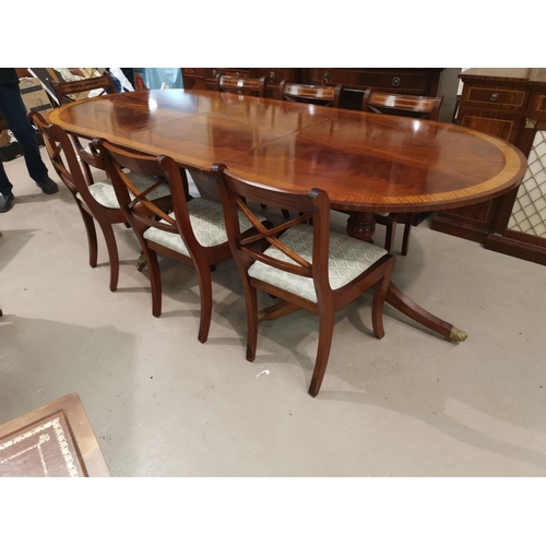 630 - A Regency style inlaid mahogany dining suite by Dickinson's of Ipswich, comprising twin pedestal ext... 