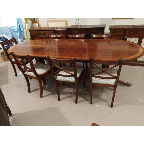 630 - A Regency style inlaid mahogany dining suite by Dickinson's of Ipswich, comprising twin pedestal ext... 