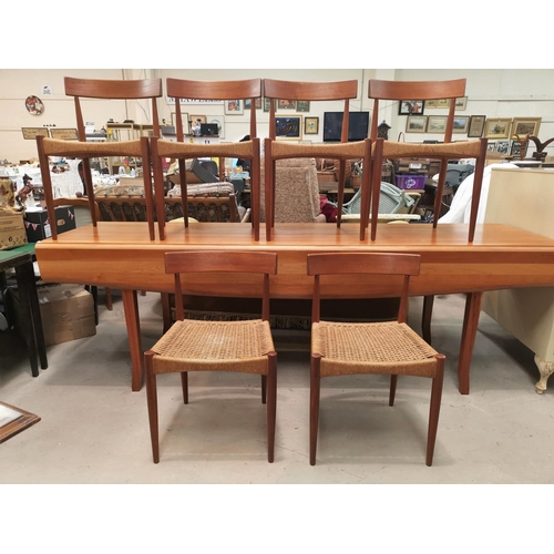 644 - A 1960's teak Danish dining suite of 6 chairs with rail backs and raffia seats, bearing badge MK Cra... 