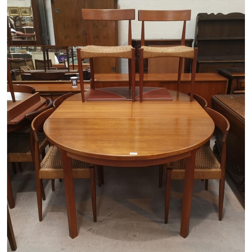 644 - A 1960's teak Danish dining suite of 6 chairs with rail backs and raffia seats, bearing badge MK Cra... 