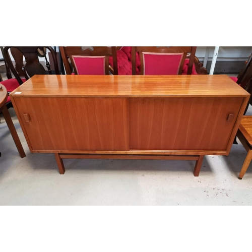 645 - A 1960's teak sideboard with double sliding doors, drawers and interior shelves, by Nils Jonsson for... 