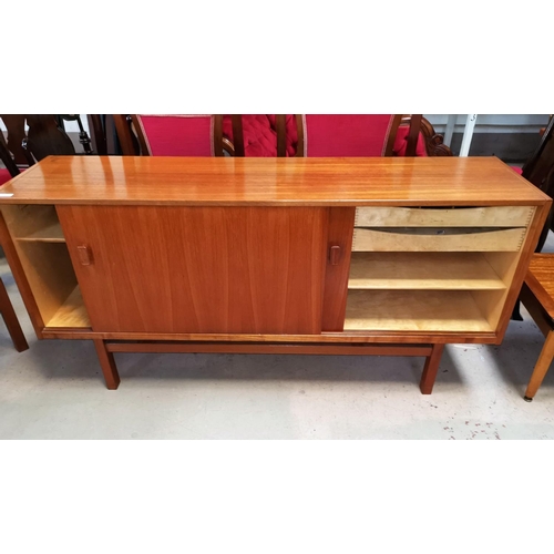 645 - A 1960's teak sideboard with double sliding doors, drawers and interior shelves, by Nils Jonsson for... 