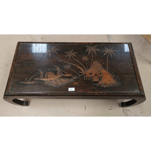 603 - A Chinese carved hardwood coffee table with glass top