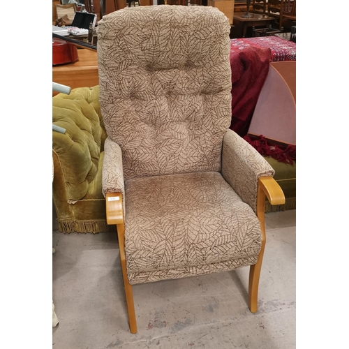 616 - A modern high back deeply buttoned arm chair in fawn upholstery