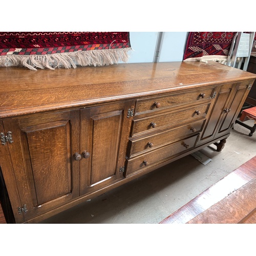 607 - An oak Priory style sideboard