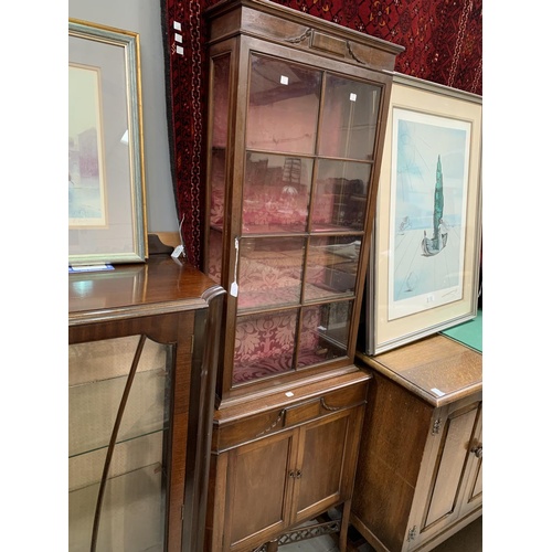 661 - An Edwardian full height thin display cabinet with glazed top cupboard and door bellow (one back leg... 