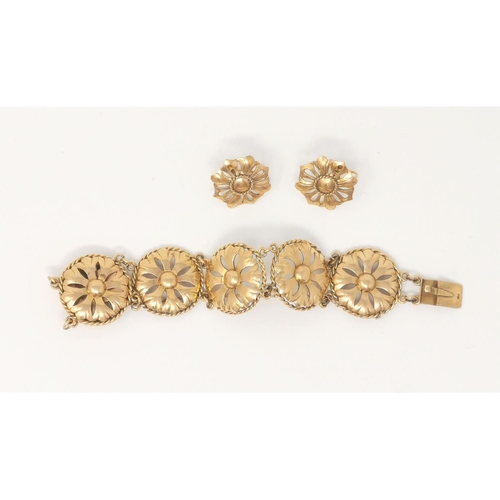 340 - A yellow metal bracelet formed from pierced flower head links, with matching earrings, stamped '10K'... 