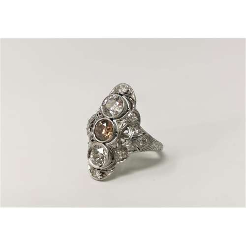 357 - An Art Deco white metal diamond dress ring with 3 central diamonds mounted vertically, the middle st... 