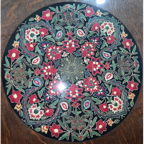 453 - An embroidered circular panel with floral motifs, diameter 38 cm, framed; a circular embroidery of a... 