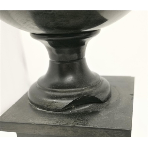 425 - A pair of polished black slate mantel urns on square bases, brass finials, 31 cm