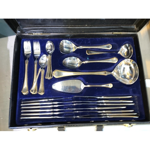 310 - An Amefa deluxe canteen of cutlery, stainless steel and gilt, in fitted attaché case